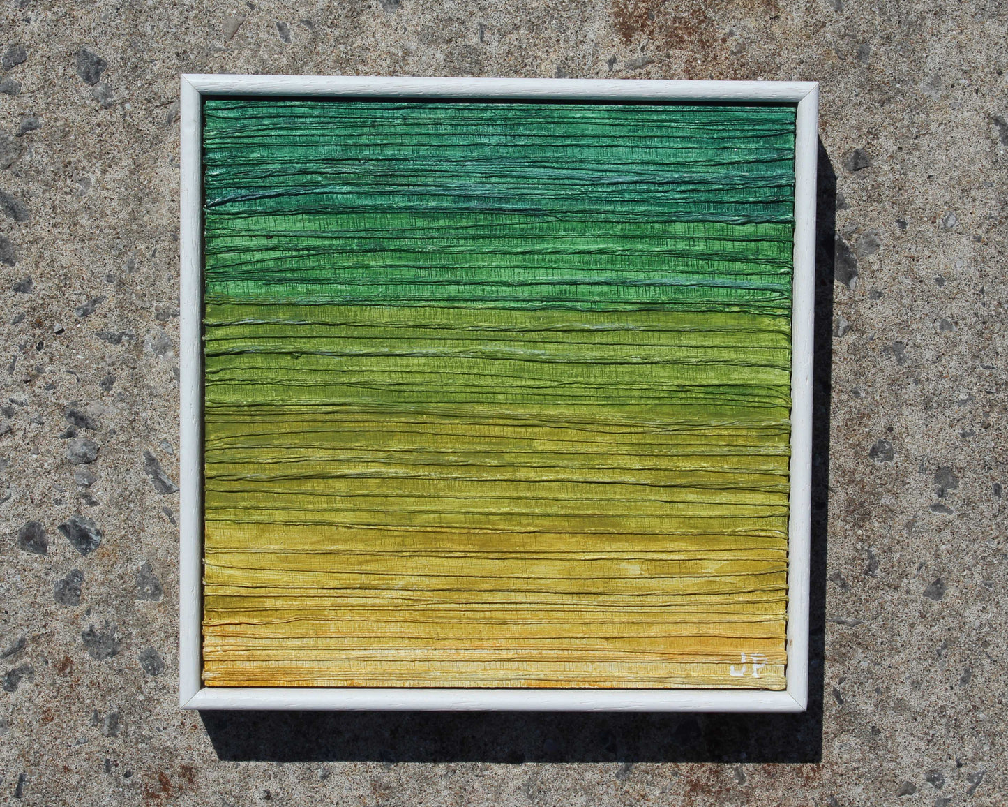 Color swatch with green to yellow gradient on a textured surface