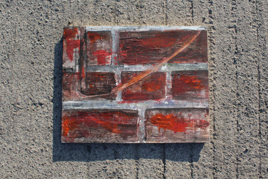 Abstract painting with red and brown tones on a textured surface