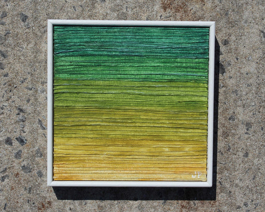 Color swatch with green to yellow gradient on a textured surface