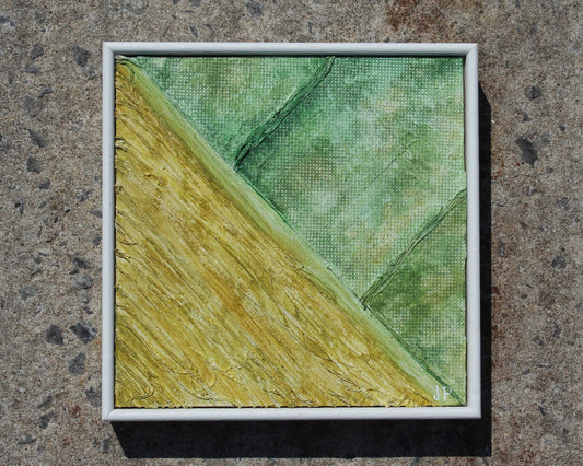 Small abstract painting with green and yellow hues on a textured surface